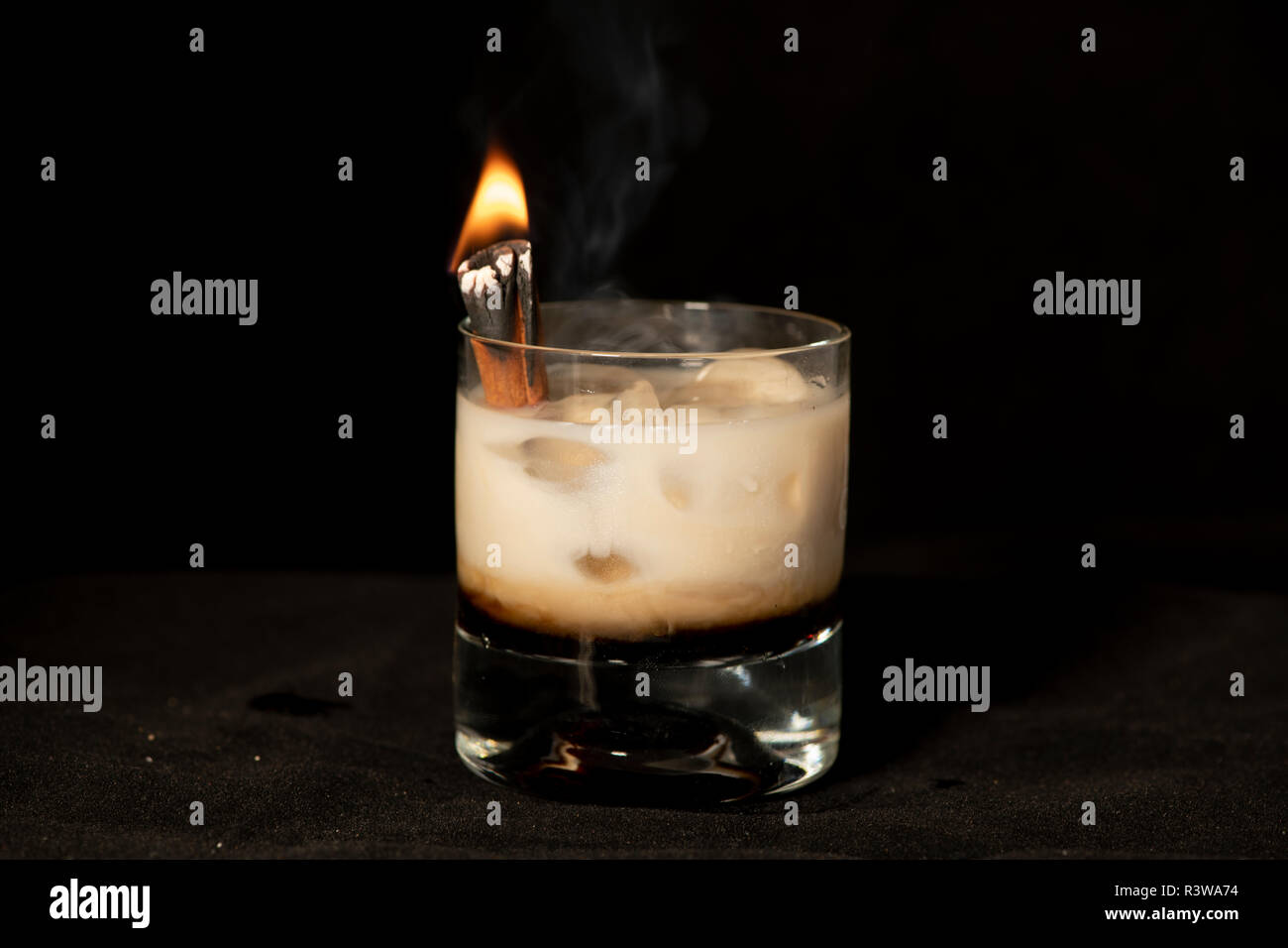 Flaming Cinnamon cocktail with kahlua, baileys irish cream and sambuca with isolated black