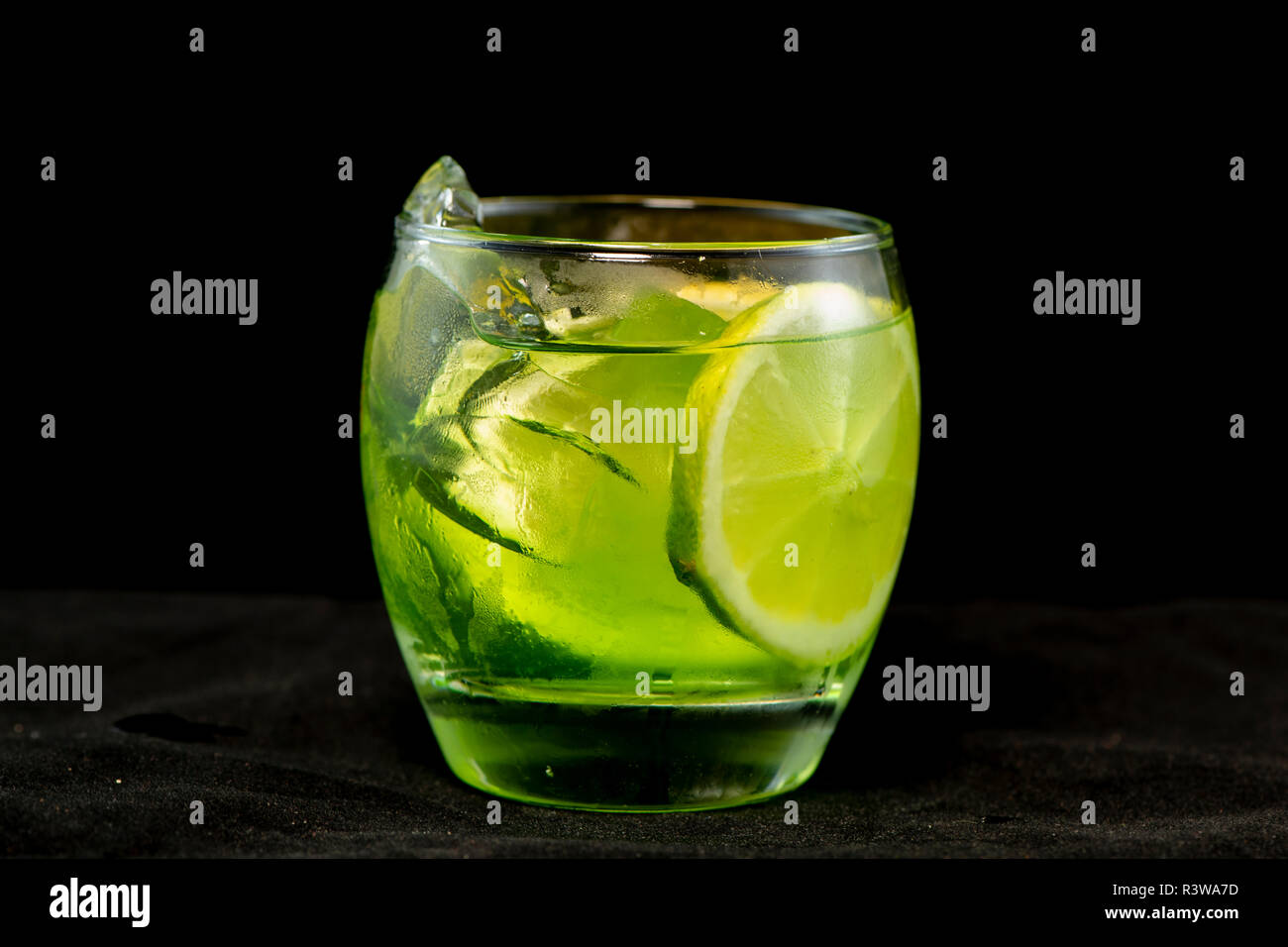 Green cocktail with gin, bitter lemon, basil and lemon with isolated