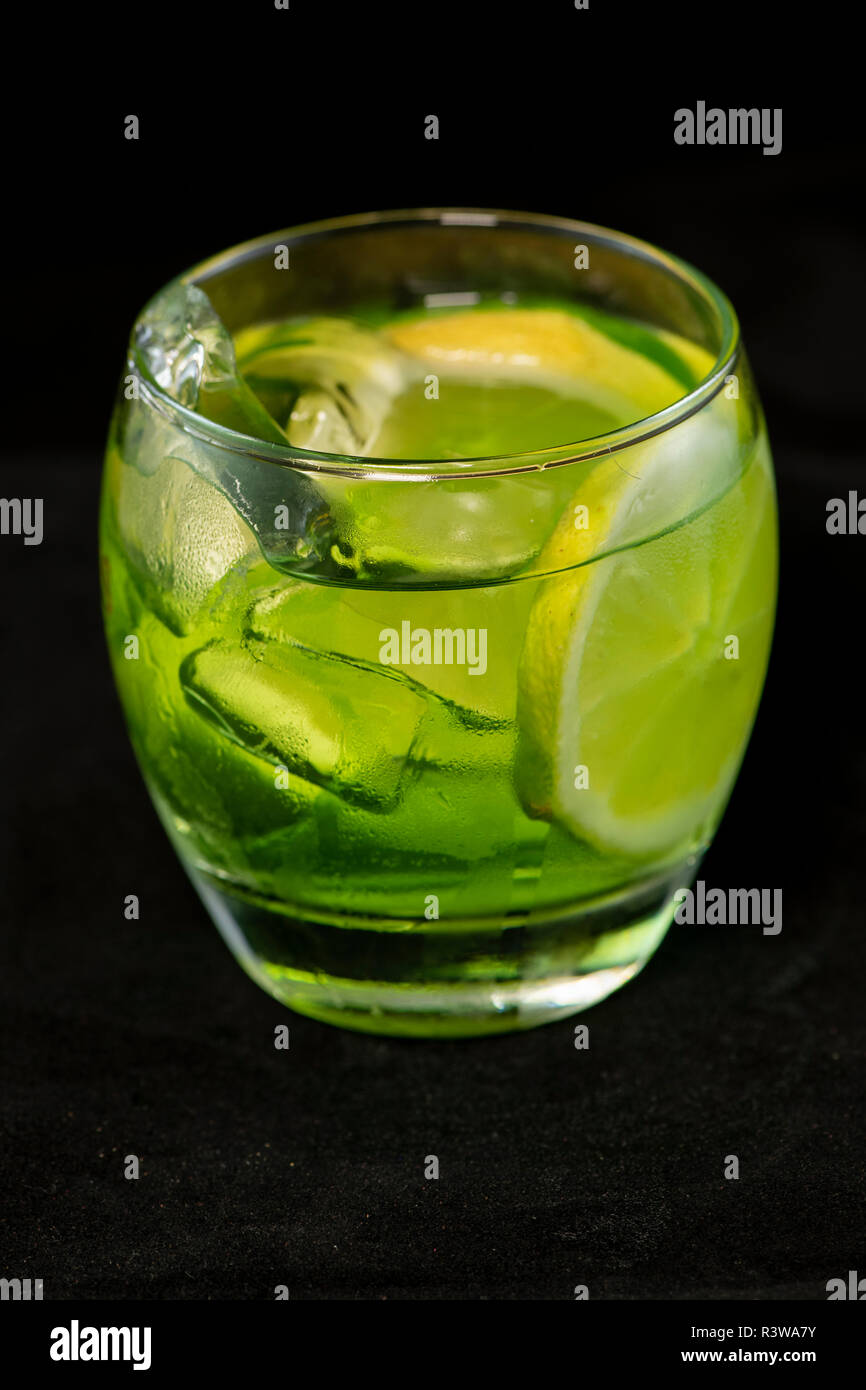 Green cocktail with gin, bitter lemon, basil and lemon with isolated