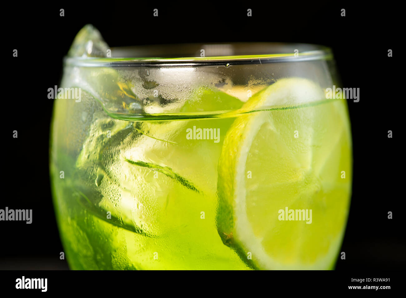 Green cocktail with gin, bitter lemon, basil and lemon with isolated