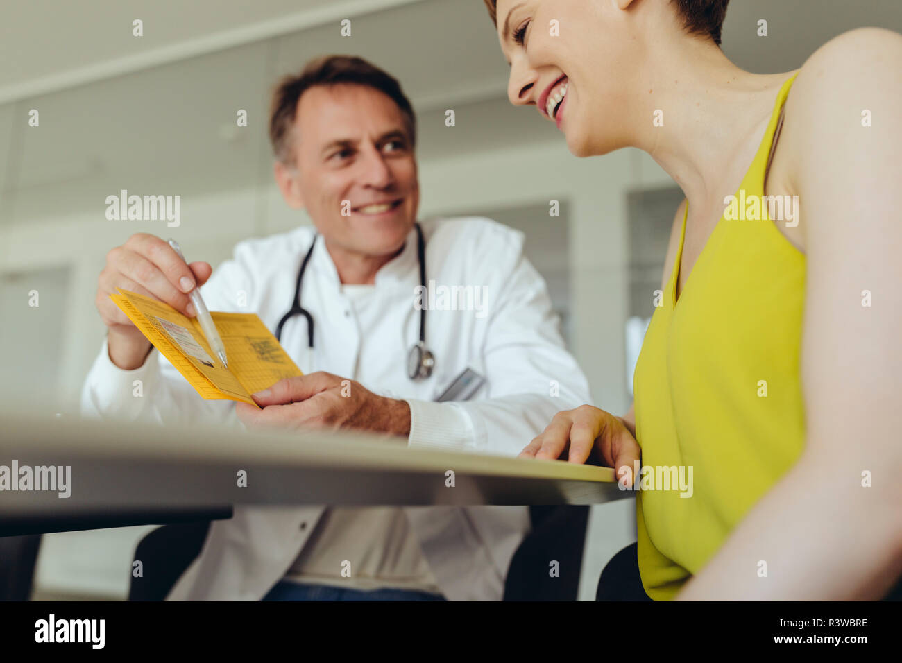 Woman discussing teatment with her doctor Stock Photo