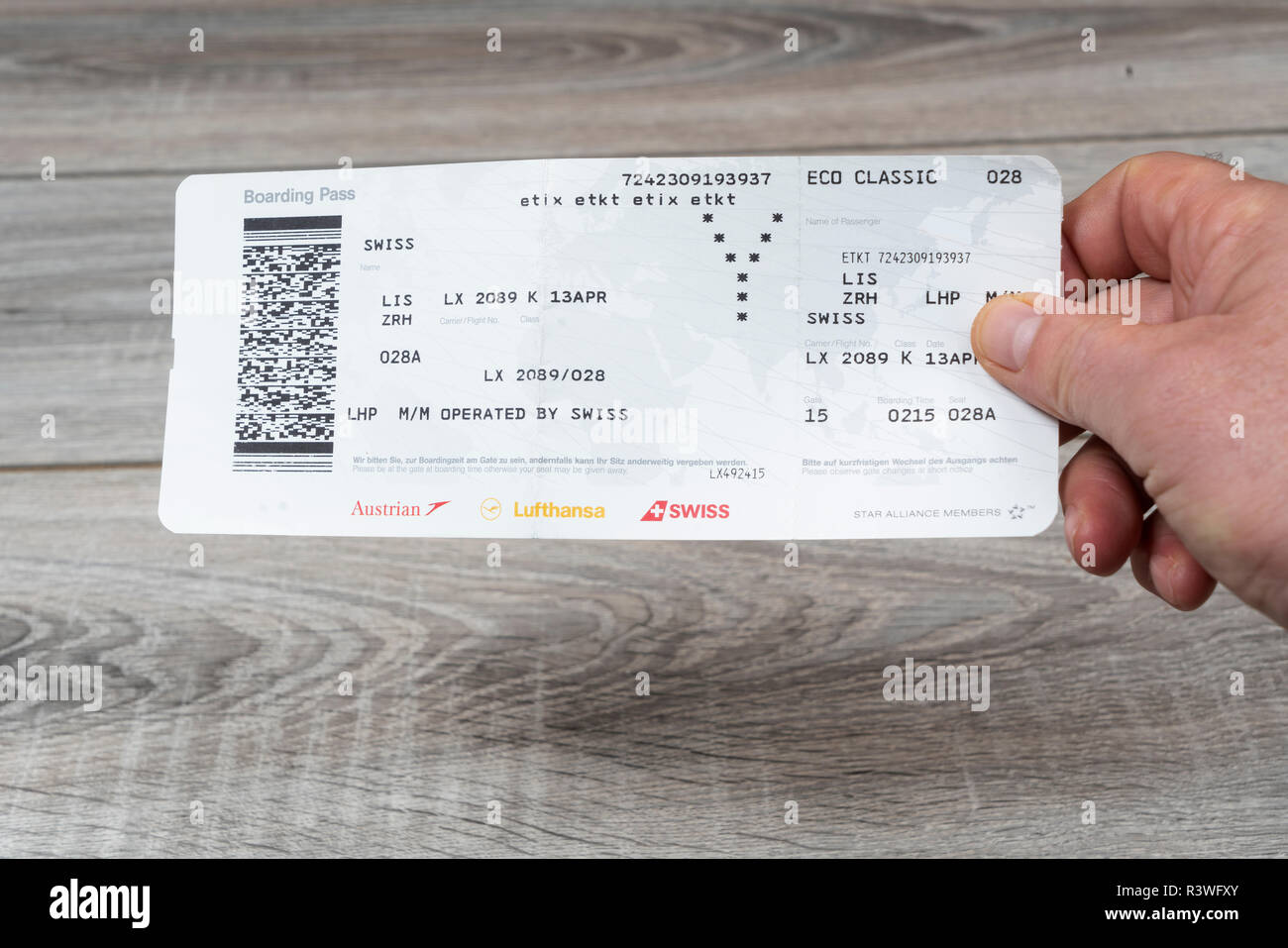 A Swiss Airlines Boarding pass on the hand Stock Photo