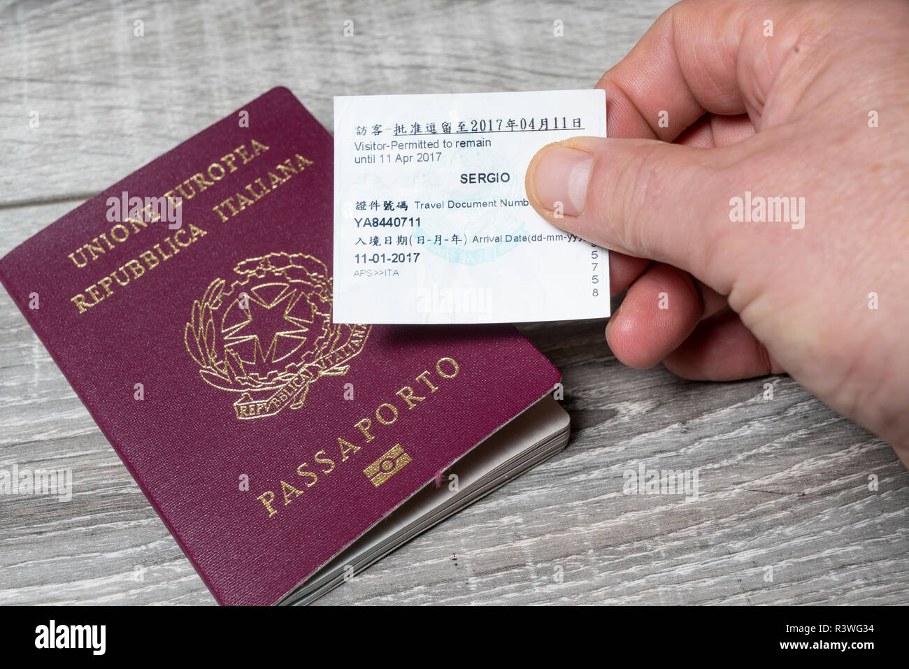 The itralian passport with the Hong Kong visa ticket on the hand Stock  Photo - Alamy