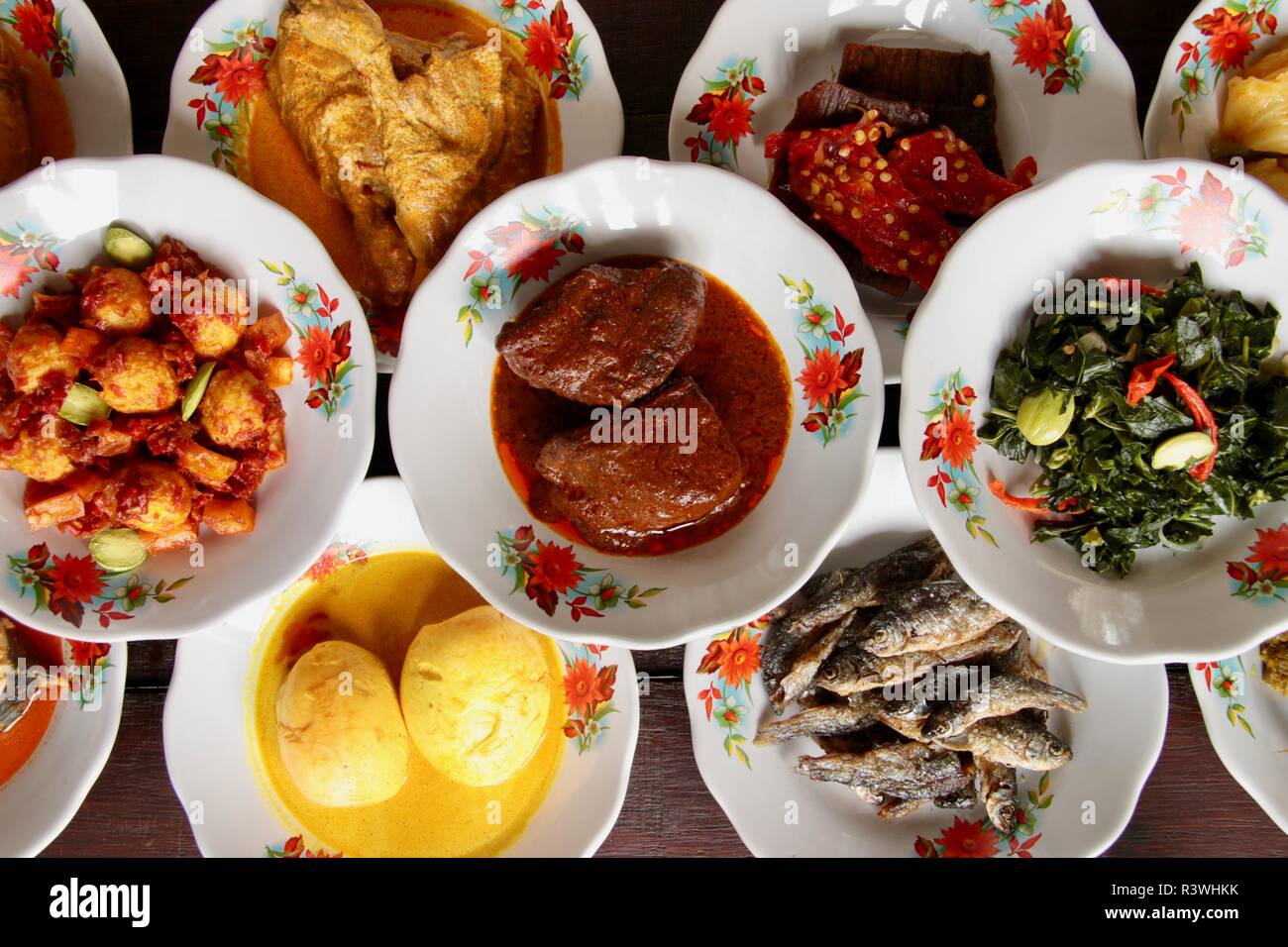 Assortment of Padang/Minang dishes served in traditional 'hidang' style. Stock Photo