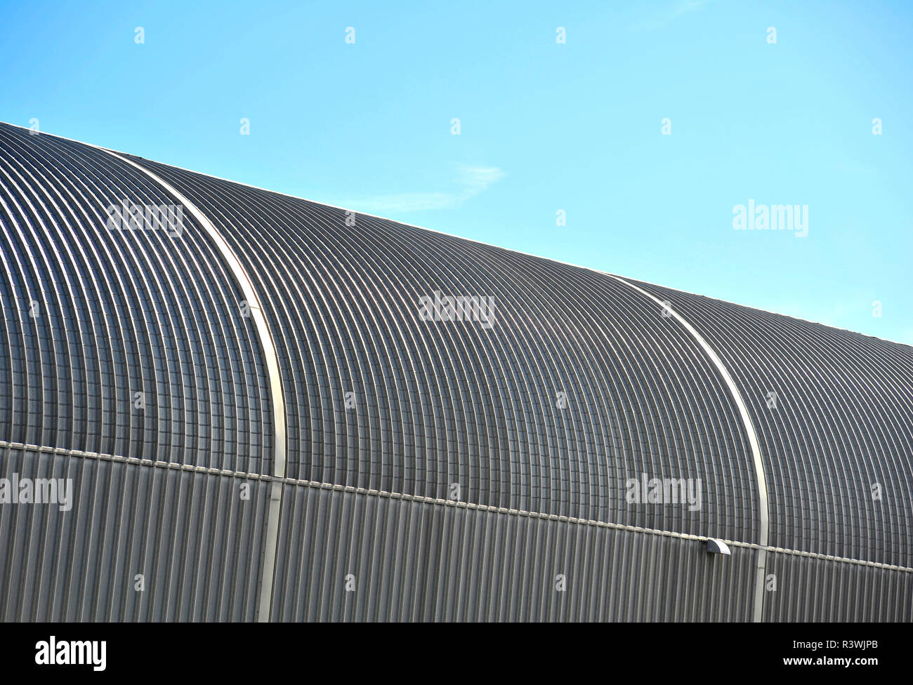 Curved steel structure of Blackpool tram depot against blue sky Stock Photo