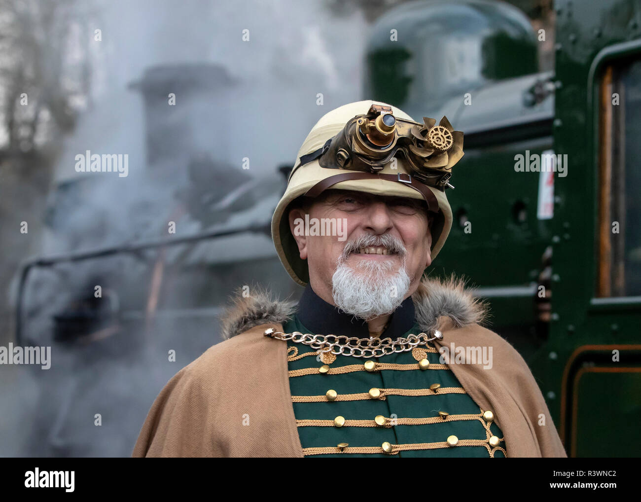 A steampunk next to a steam locomotive during the Haworth Steampunk Weekend, as hundreds of Steampunks descend on the quite village of Haworth in the Pennine hills of West Yorkshire, England. Stock Photo