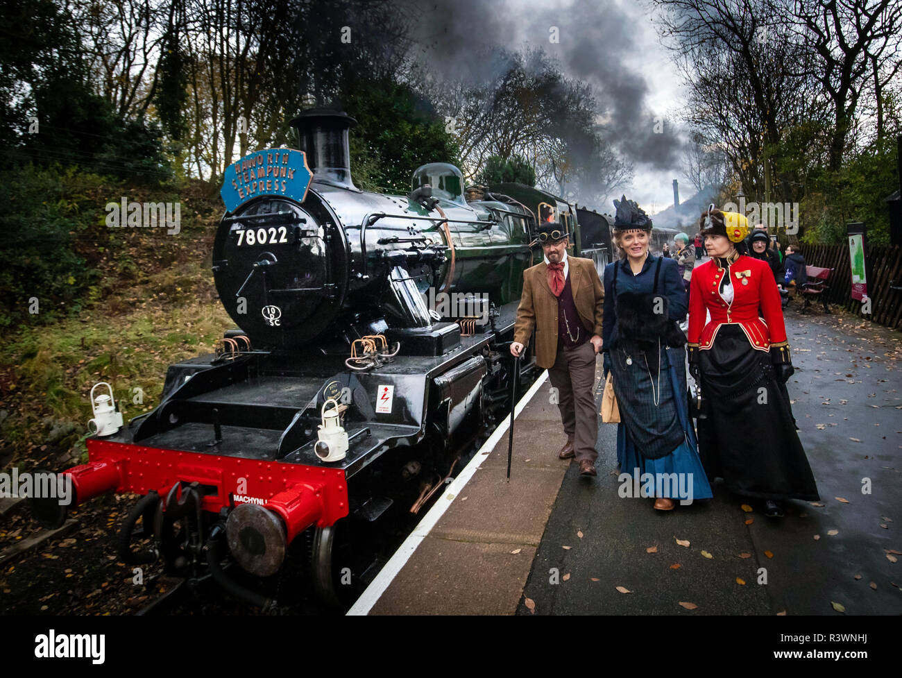 Steampunks next to a steam locomotive during the Haworth Steampunk Weekend, as hundreds of Steampunks descend on the quite village of Haworth in the Pennine hills of West Yorkshire, England. Stock Photo