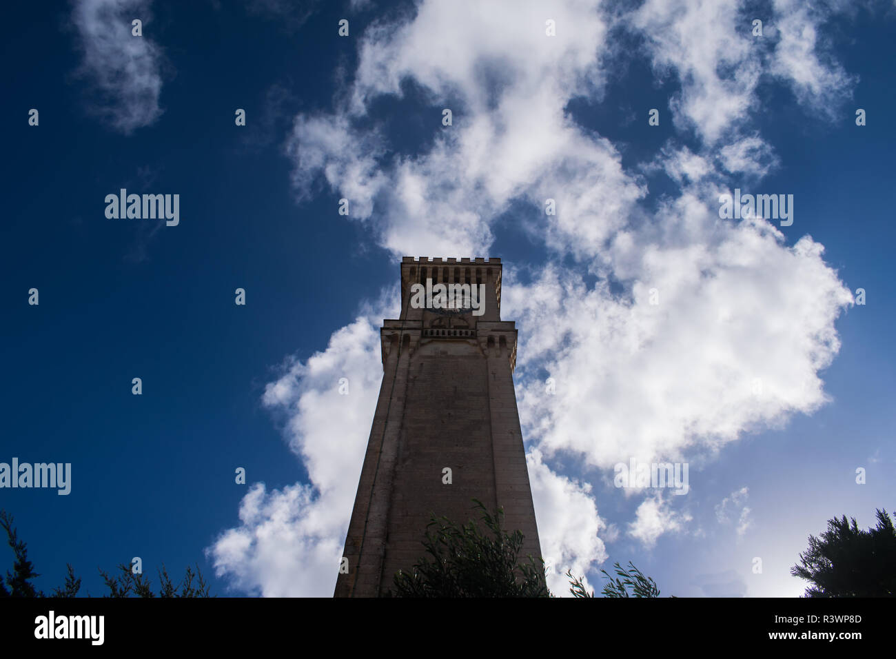 Feeling small while looking up at the Baroque style clock tower located in Mtarfa, Malta. Stock Photo