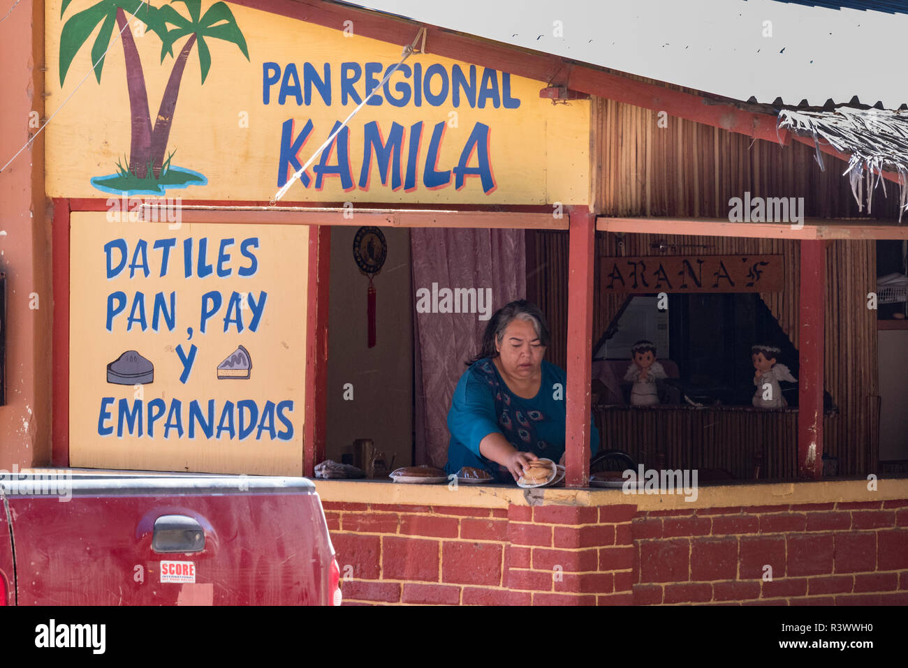 Baja California, Mexico. Woman behind a stand selling date pie and empanadas in San Ignacio. Stock Photo