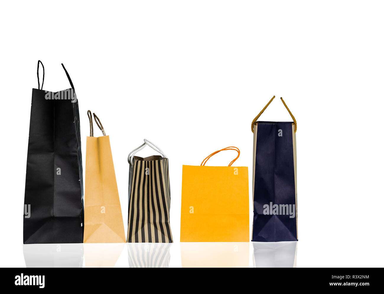Five paper shopping bags isolated on white background. Shopping bag with blue, brown, and yellow color. Discount sales concept. Gift bag. Consumerism  Stock Photo