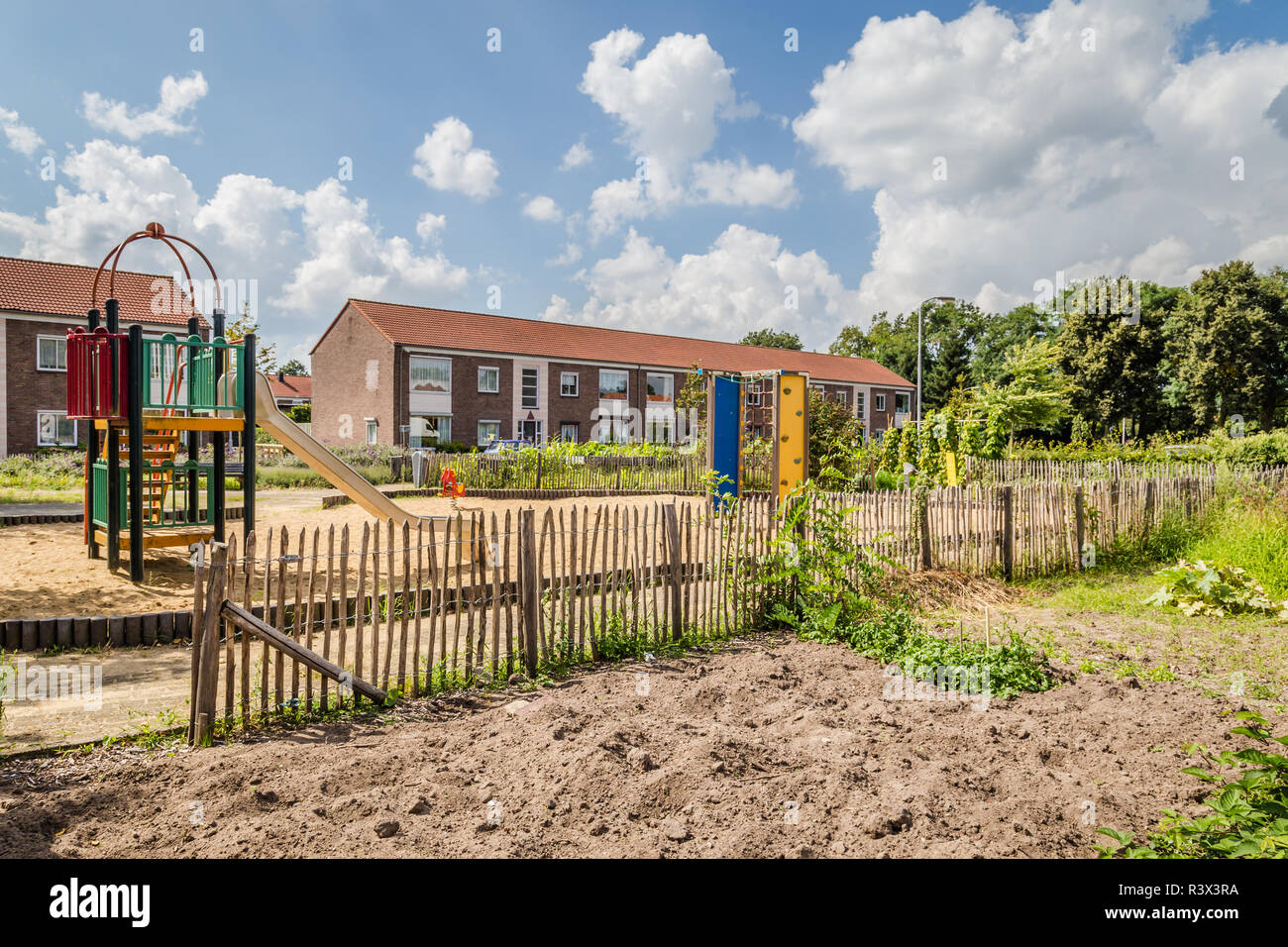 Picture of Urban agriculture: a vegetable garden beside an apartment building in ...