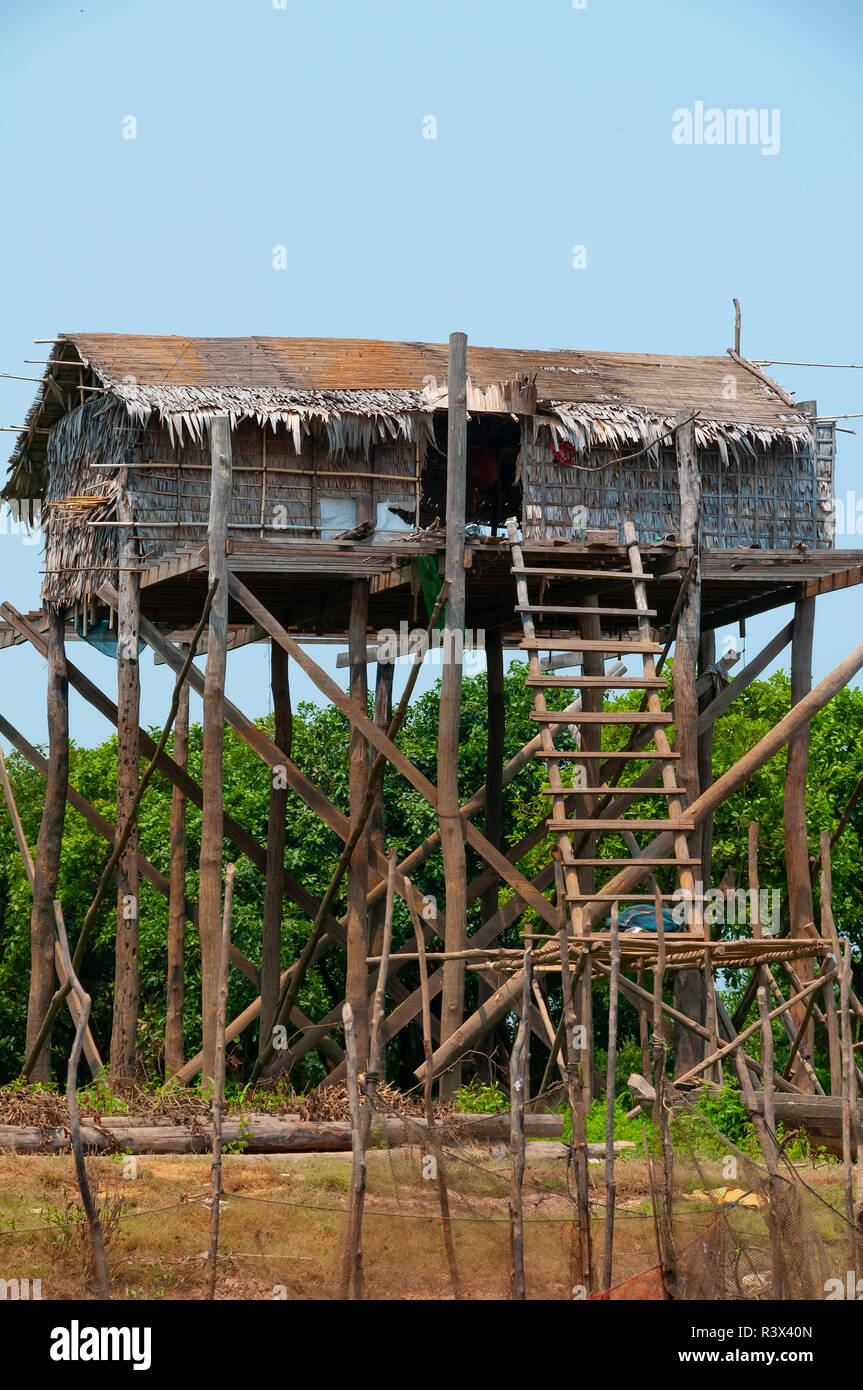 Stilt or stilted fishing village house, in the dry season, situated on the banks of an estuary connecting it to Tonle Sap Lake,Cambodia Stock Photo