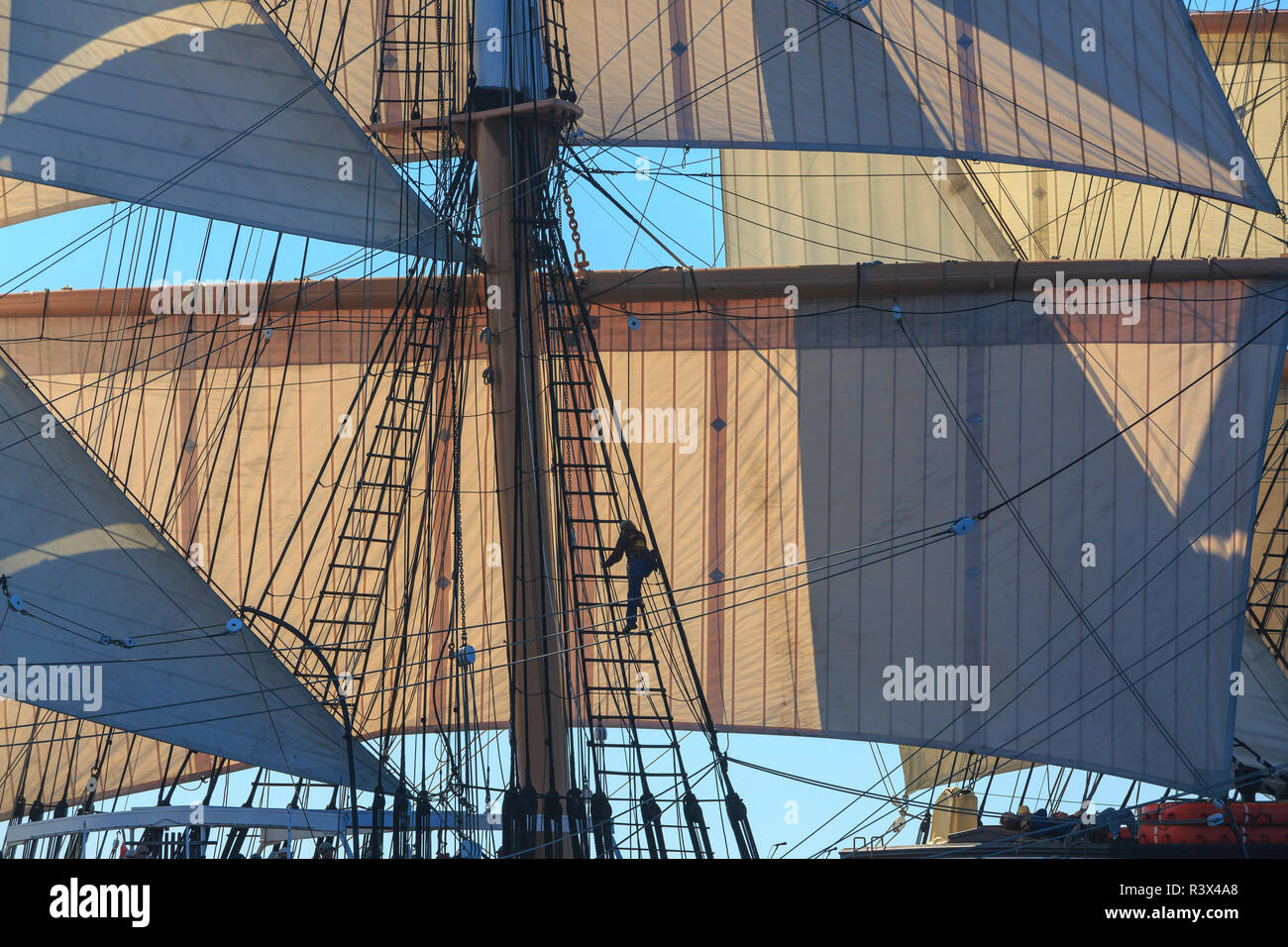 Ship Climbing Rigging Man climbing the rigging of a tall ship sailboat. San Diego, California ...