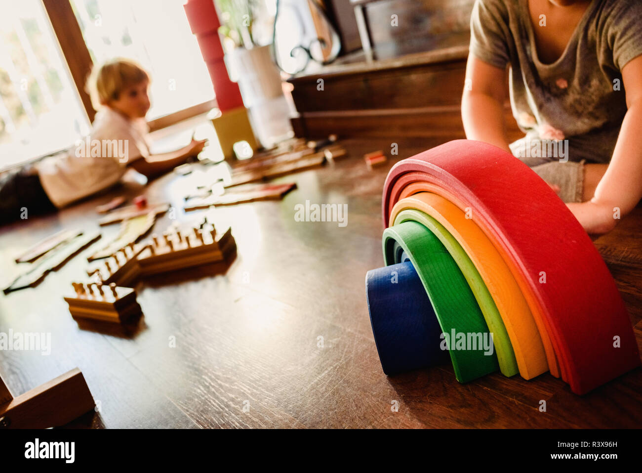 Children playing with wooden rainbow waldorf montessori Stock Photo - Alamy