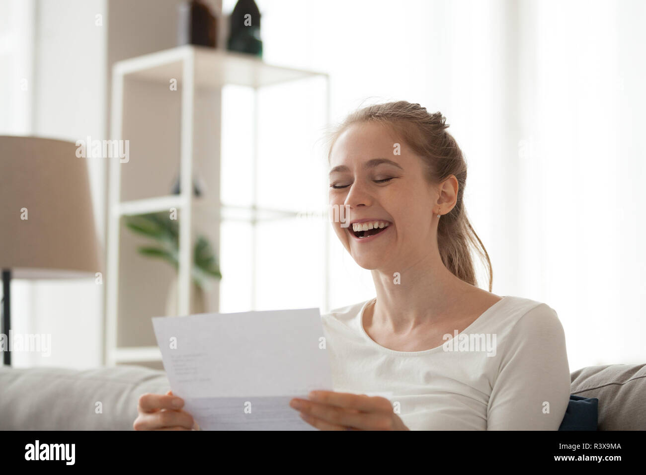 Excited female reading letter getting good news Stock Photo