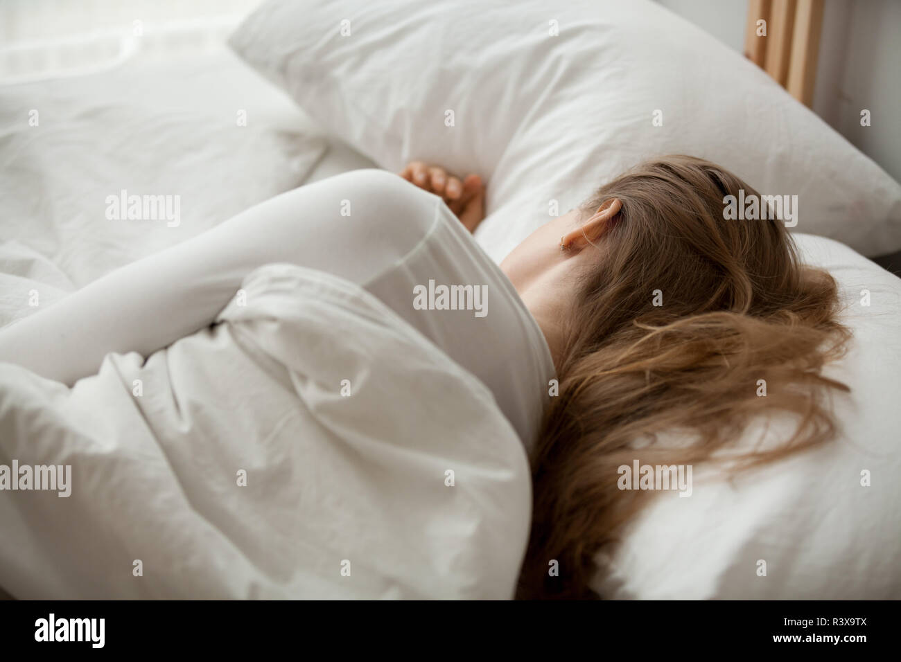 Female sleep on white sheets relaxing in cozy bedroom Stock Photo Alamy