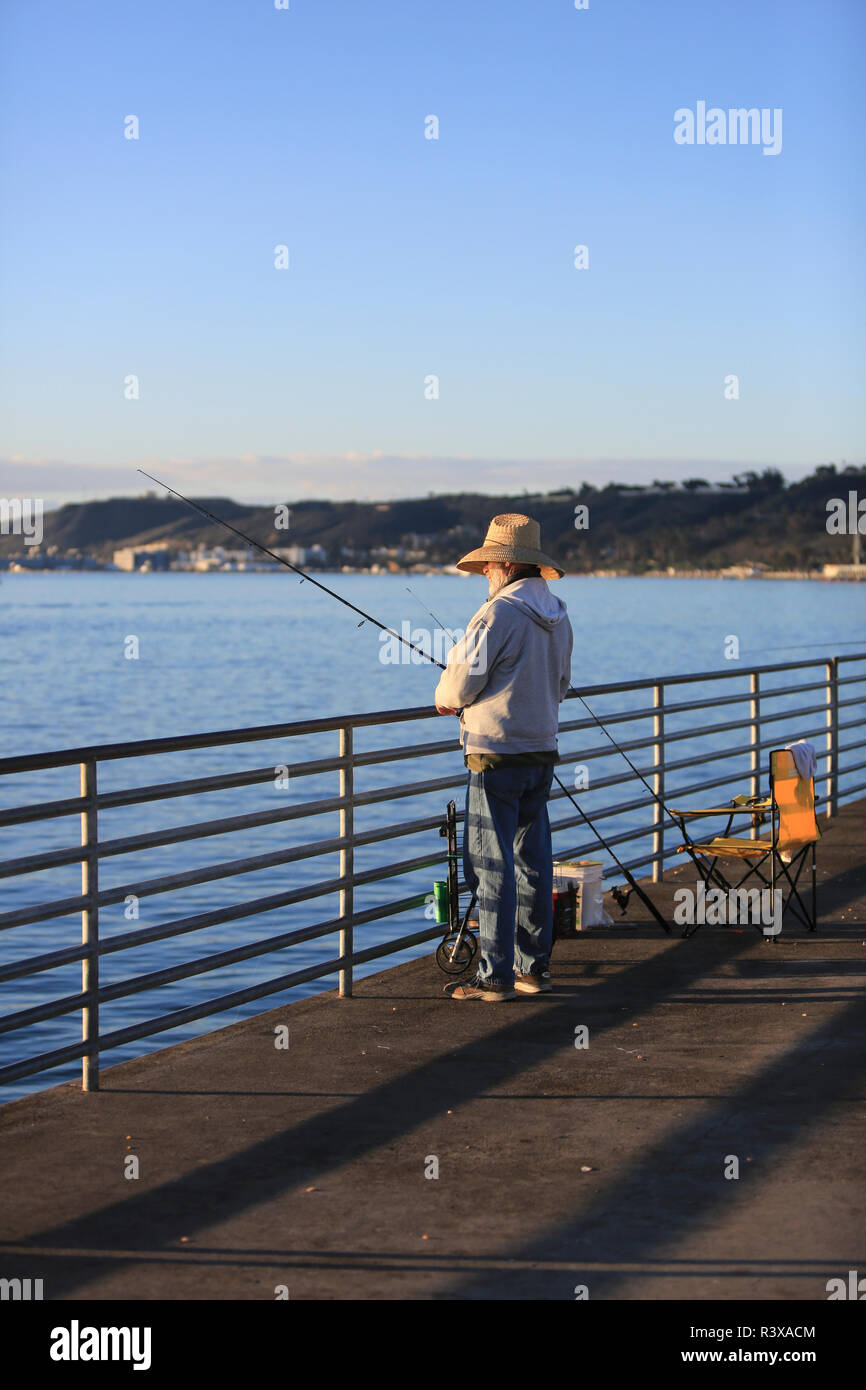 Shelter Island, San Diego, California. Fisherman wearing a straw hat