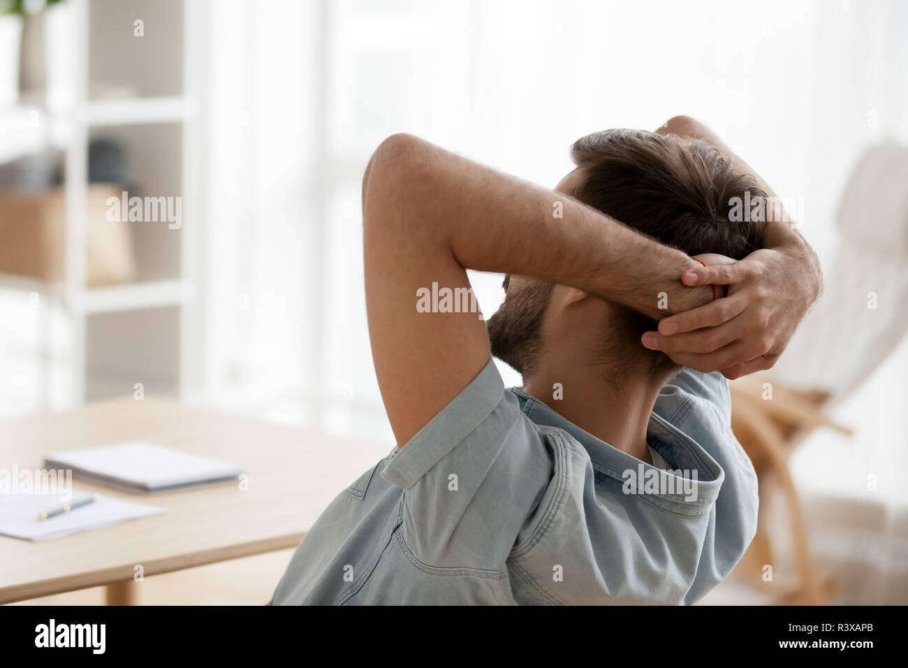 Man leaning back in chair hires stock photography and images Alamy