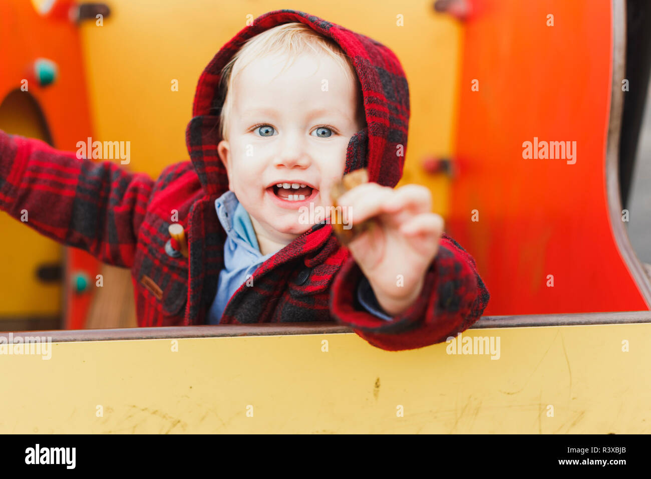 Baby laughing funny while playing on the floor. Stock Photo