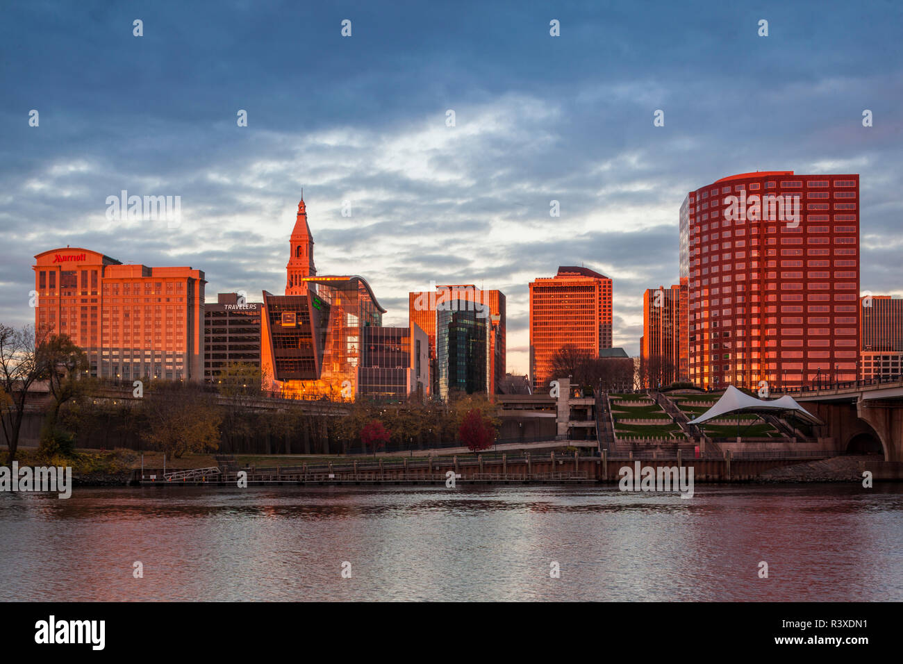 USA, Connecticut, Hartford, city skyline with Connecticut Science Center and Travelers Building, from the Connecticut River at dawn, autumn Stock Photo