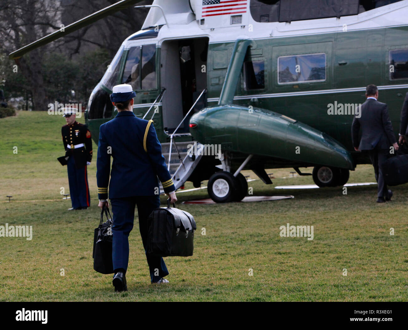 The military aide walks to Marine One with the football for President Donald Trump on January 25, 2017. Stock Photo
