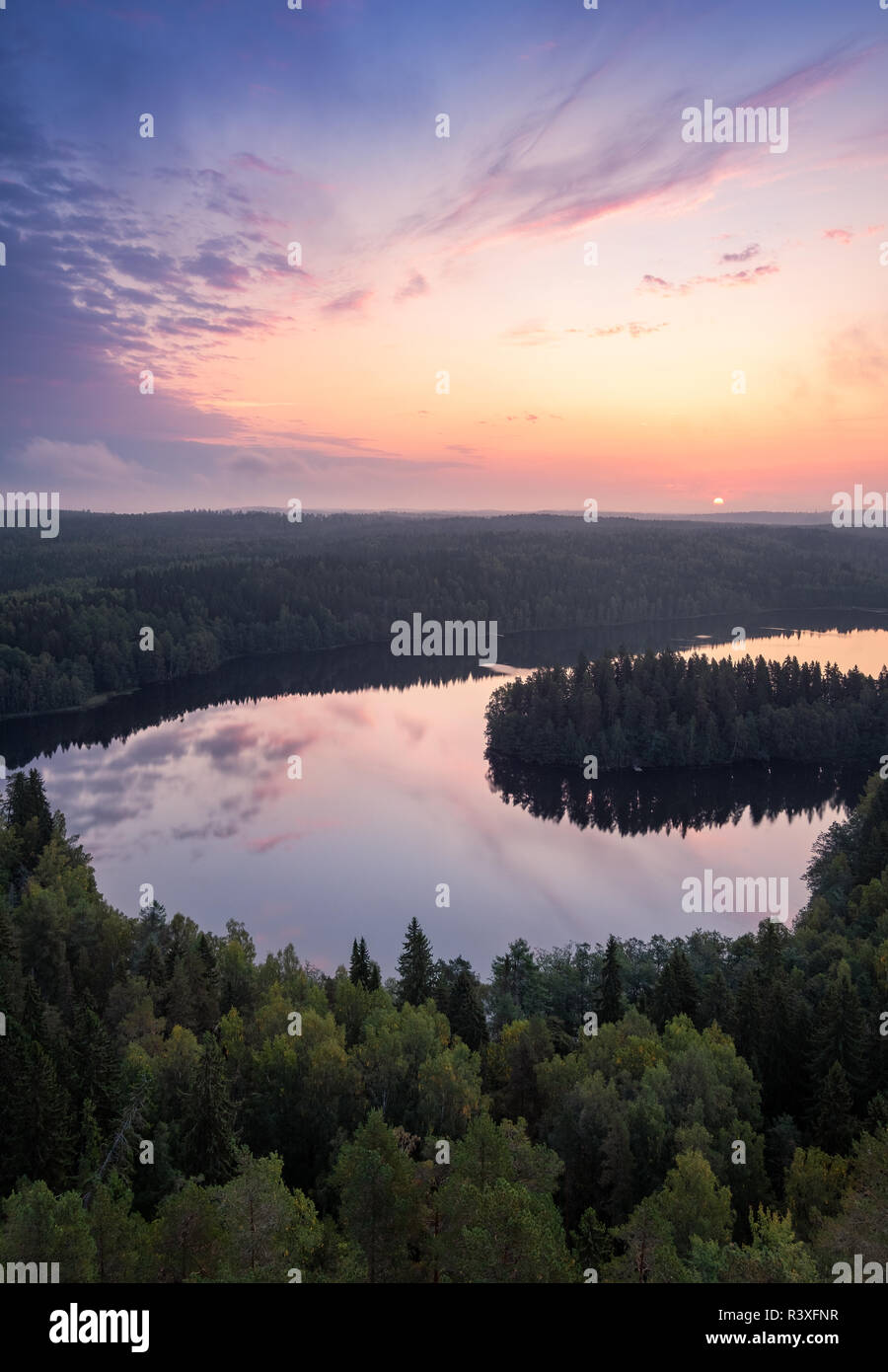 Scenic high angle landscape with sunrise, forest and lake at autumn morning in nature reserve, Finland Stock Photo