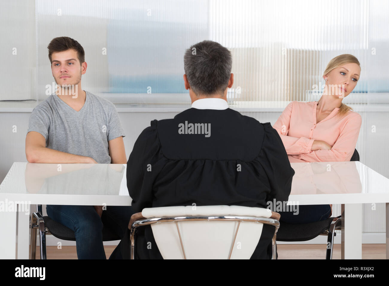 Judge In Front Of A Unhappy Couple Stock Photo