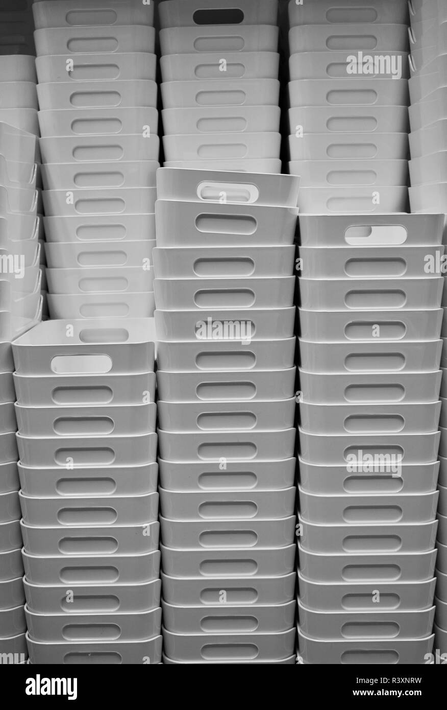 Stack of white plastic storage boxes with handles Stock Photo
