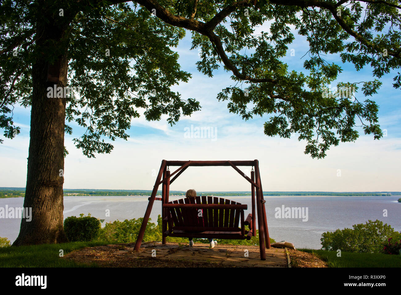 Relaxing in a swing above the Mississippi River Stock Photo