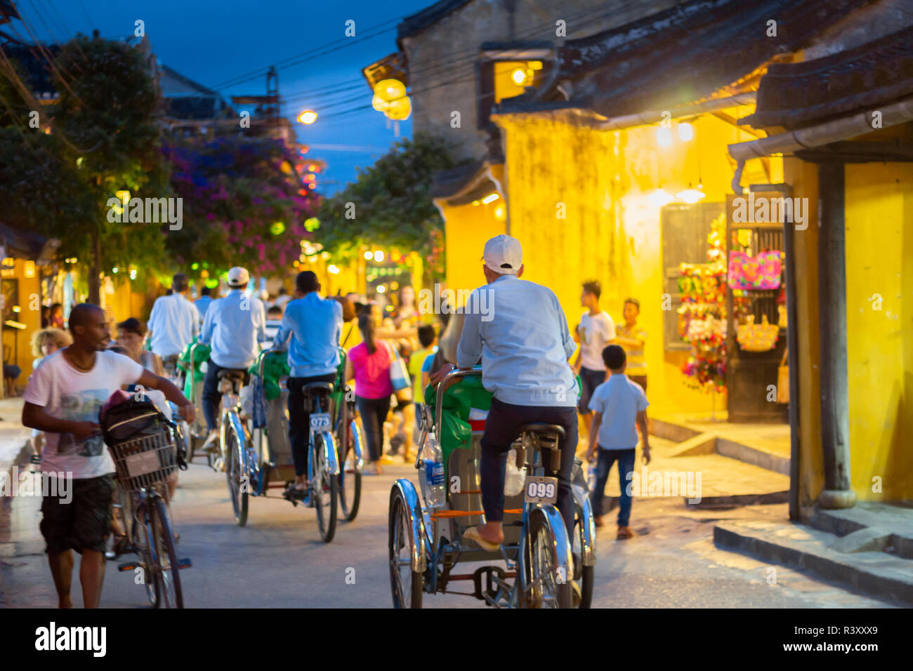 trishaws cycle rickshaws riding tourists around Hoi An Ancient Town. Stock Photo