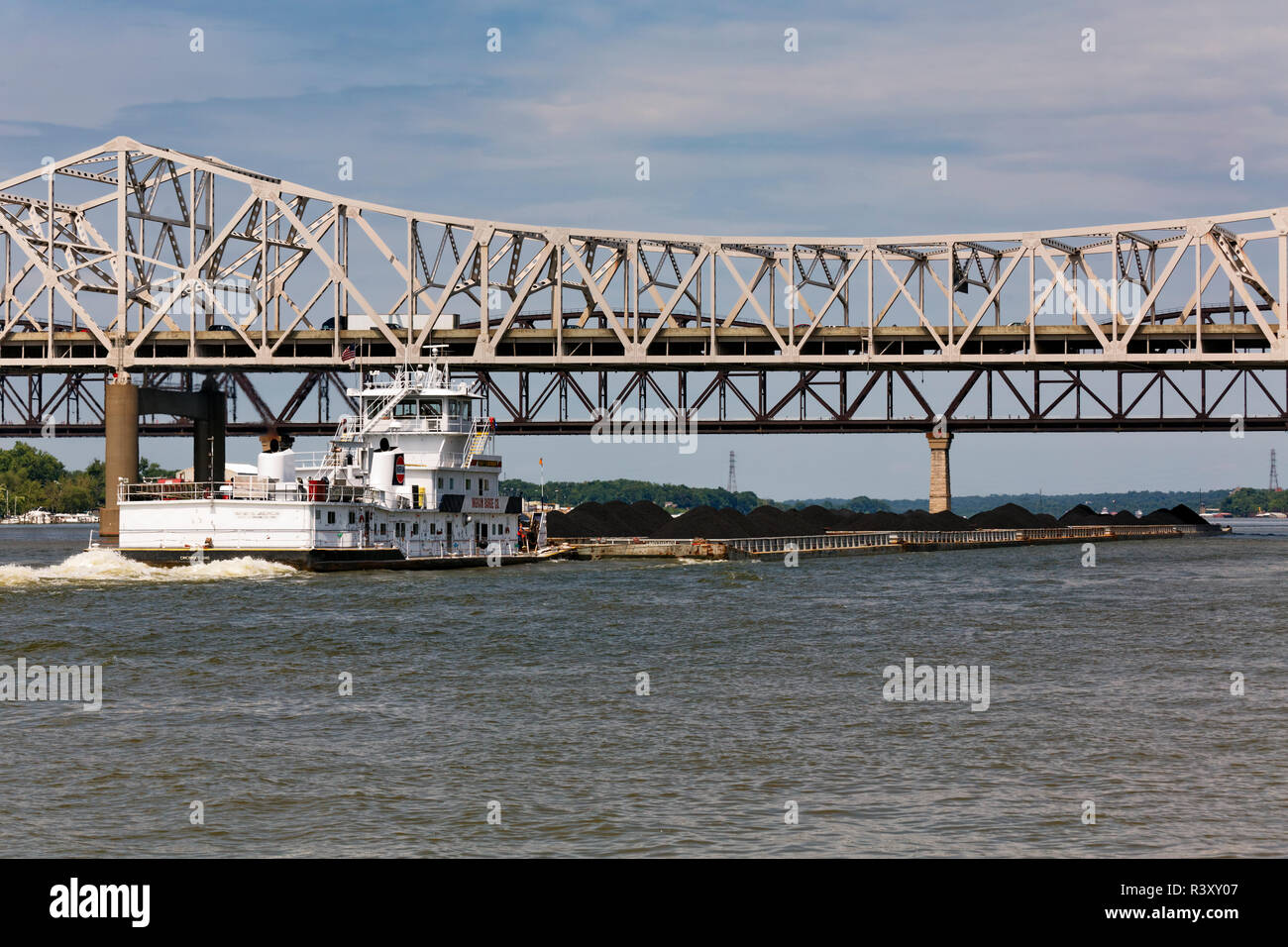 Barge loaded with coal going up the Ohio River, between Louisville, Kentucky and Jeffersonville, Indiana Stock Photo