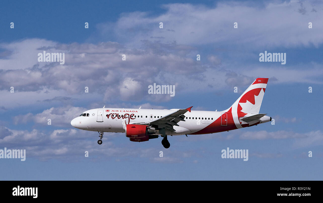 Air Canada 'Rouge' Airbus A319 Flying in Beautiful Sky Stock Photo