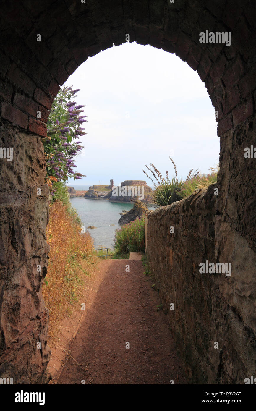 Looking back along the coastal path to Dunbar Castle, Dunbar, Scotland Stock Photo