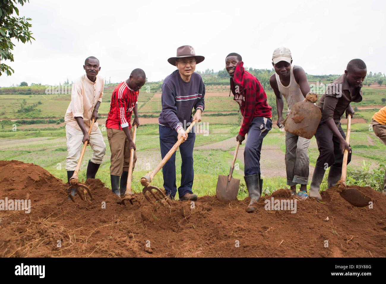 (181124) -- KAMONYI (RWANDA), Nov. 24, 2018 (Xinhua) -- Chinese Ambassador to Rwanda Rao Hongwei (3rd L) participates in monthly community work, Umuganda, in Kamonyi district, central Rwanda, on Nov. 24, 2018. Diplomatic missions in Rwanda and Rwandan Ministry of Foreign Affairs and International Cooperation on Saturday organized a diplomatic Umuganda in Kamonyi. Taking root from Rwandan culture of self-help and cooperation, Umuganda, held on the last Saturday of the month, can be translated as "coming together in common purpose to achieve an outcome," according to Rwanda Governance Board. (Xi Stock Photo