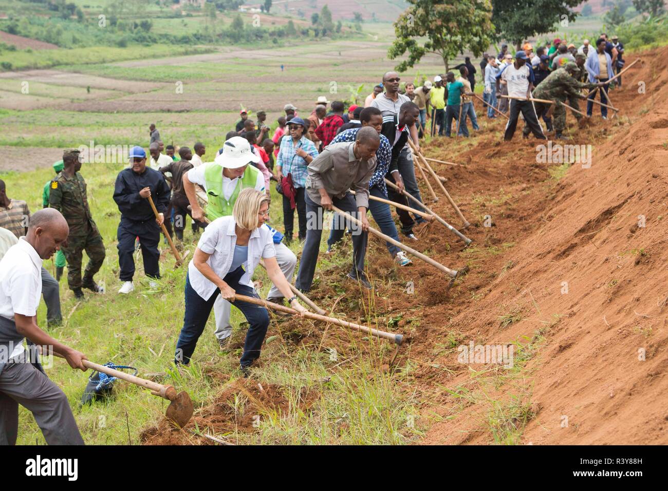 (181124) -- KAMONYI (RWANDA), Nov. 24, 2018 (Xinhua) -- Foreign diplomats in Rwanda, Rwandan officials and residents participate in monthly community work, Umuganda, in Kamonyi district, central Rwanda, on Nov. 24, 2018. Diplomatic missions in Rwanda and Rwandan Ministry of Foreign Affairs and International Cooperation on Saturday organized a diplomatic Umuganda in Kamonyi. Taking root from Rwandan culture of self-help and cooperation, Umuganda, held on the last Saturday of the month, can be translated as "coming together in common purpose to achieve an outcome," according to Rwanda Governance Stock Photo