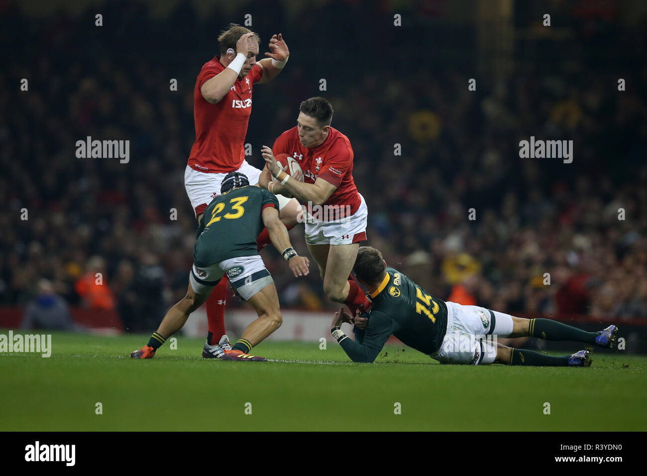 Josh Adams of Wales is tackled by Willie Le Roux of South Africa (15) and Cheslin Kolbe of South Africa (23)