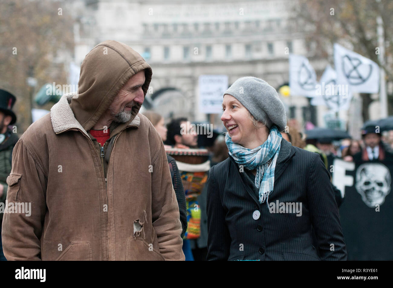 Extinction Rebellion campaigners Roger Hallam (Left) and Dr Gail Bradbroock (Right) seen at the front of the march.  Thousands of demonstrators from the new Extinction Rebellion climate change movement gathered at Parliament Square for a memorial and funeral march through London. Demonstrators paid homage to the lives lost due to climate change, and marched carrying a coffin from Parliament Square to Buckingham Palace. Stock Photo