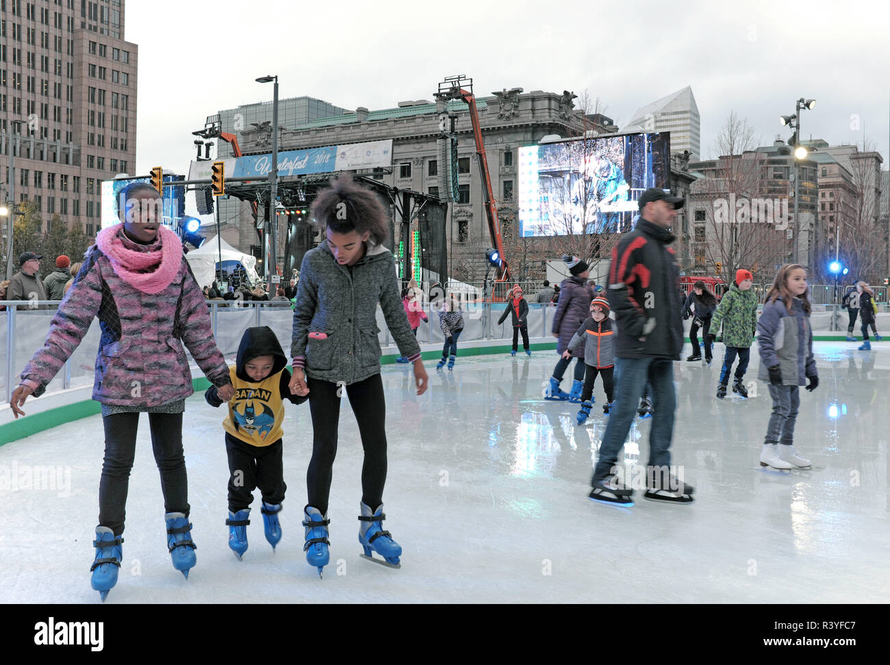 Cleveland, Ohio, USA. 24th Nov, 2018. Two girls hold the hands of a young boy as they make their