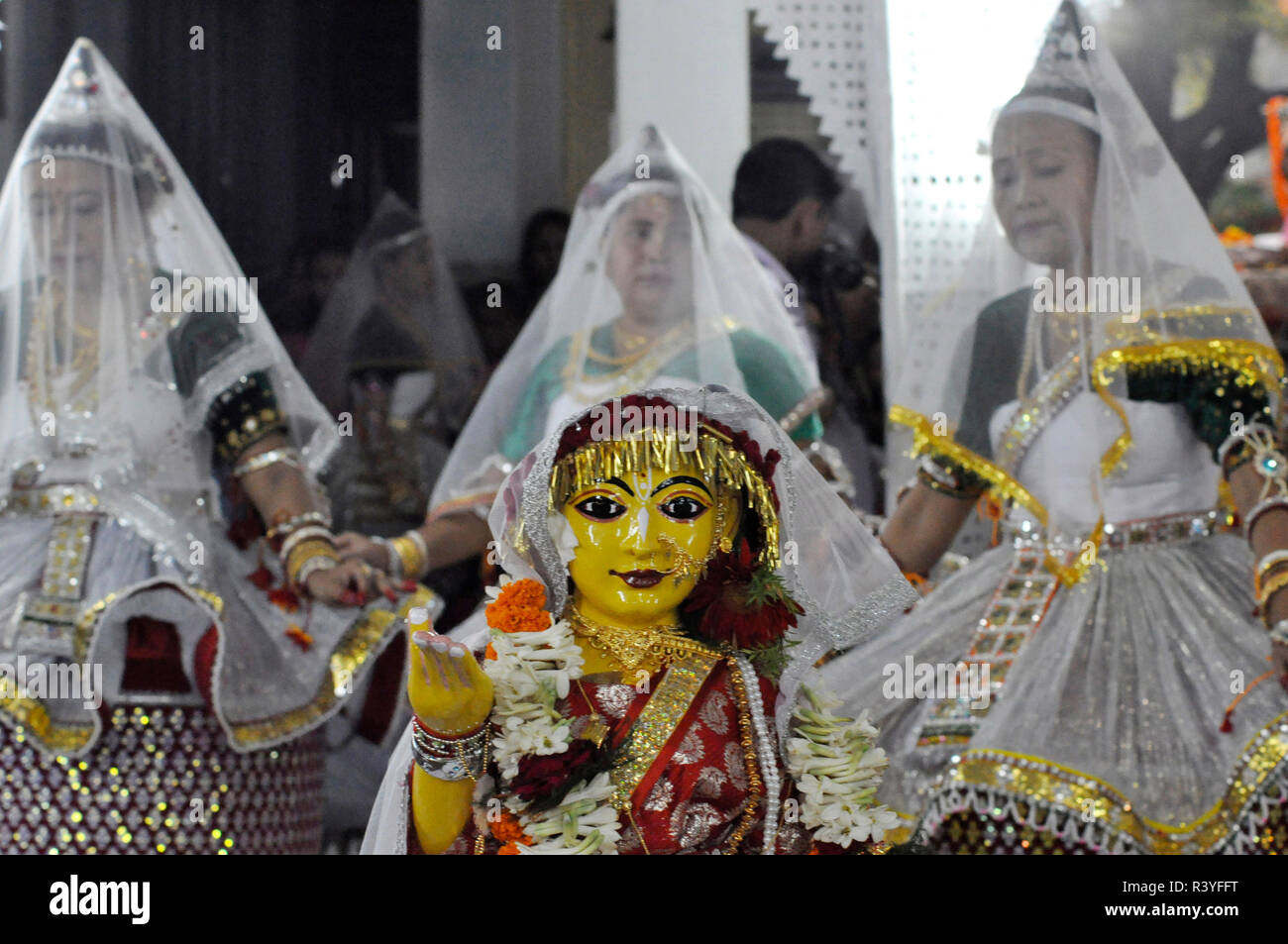 Dancers seen performing with an idol the traditional dance in RASH PURNIMA with their heads covered by veils during the birthday celebration of Shri Mahaprabhu on the Phalguni Purnima (i.e. on the Full moon day). Many devotees from around the world make a pilgrimage on the auspicious occasion. Stock Photo
