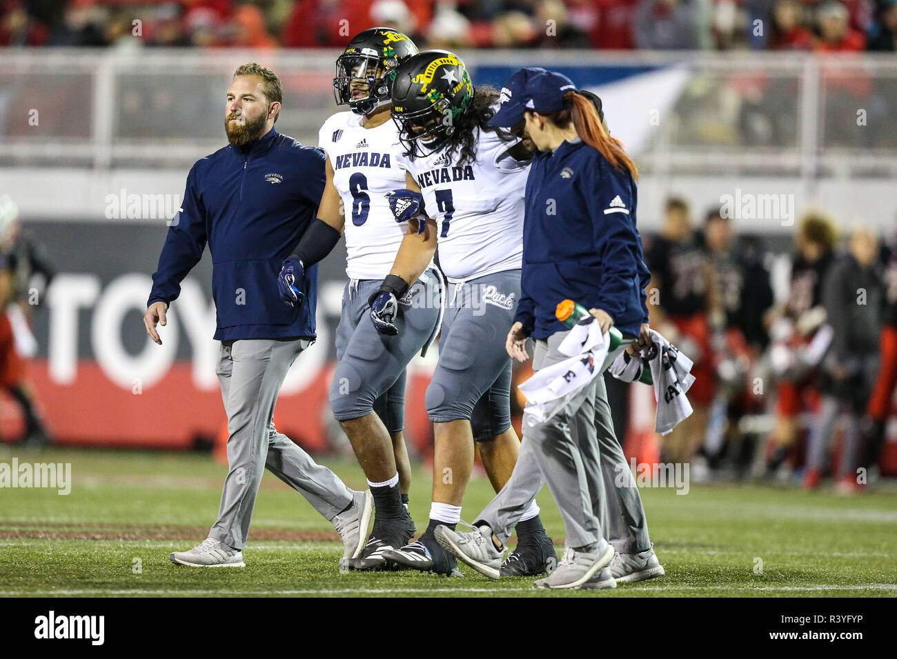 Las Vegas, NV, USA. 24th Nov, 2018. Nevada Wolf Pack linebacker Gabriel Sewell (7) is assisted off the field by his brother Nevada Wolf Pack defensive back Nephi Sewell (6) during the NCAA football game featuring the Nevada Wolf Pack and the UNLV Rebels at Sam Boyd Stadium in Las Vegas, NV. The UNLV Rebels defeated the Nevada Wolf Pack 34 to 29. Christopher Trim/CSM/Alamy Live News Stock Photo