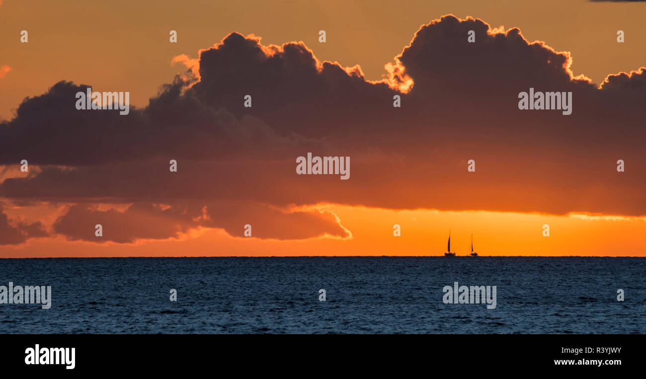 Hawaii, Maui, Kihei. Two sailboats in the distance at sunset. Stock Photo