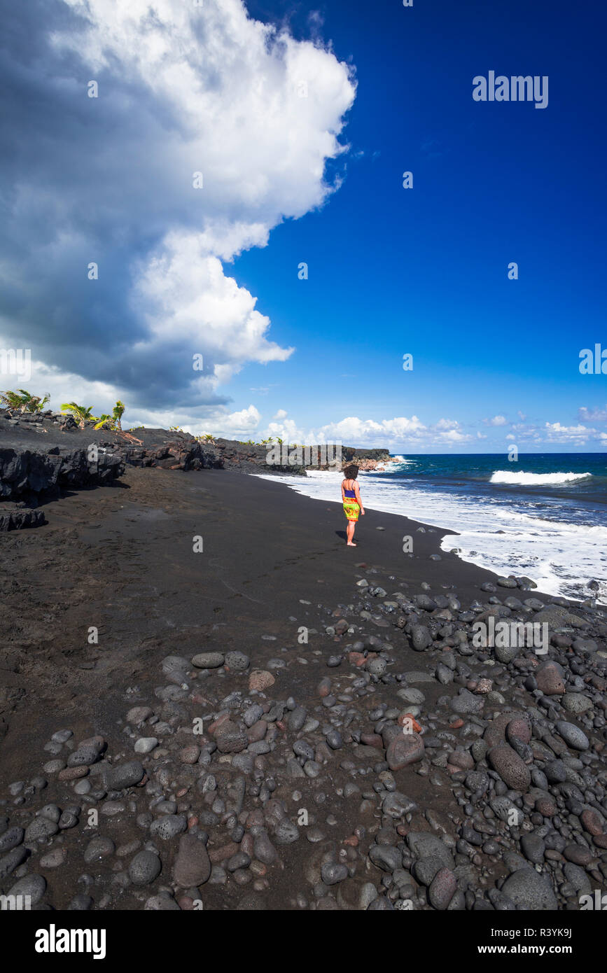 Woman on the new Kaimu black sand beach, Kalapana, Big Island, Hawaii