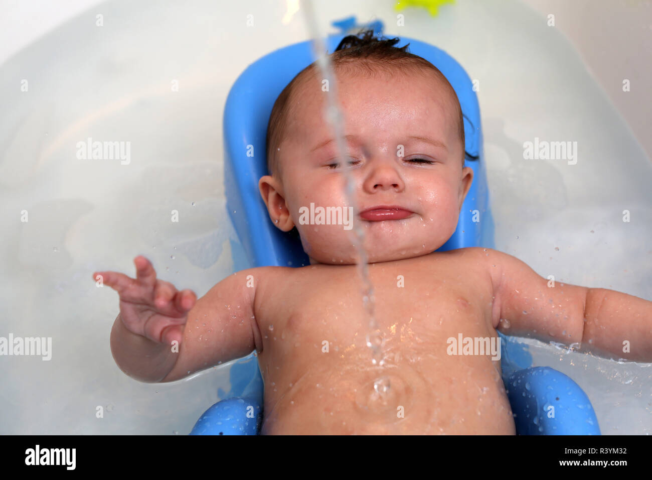 Baby in bath using a bath support Stock Photo Alamy