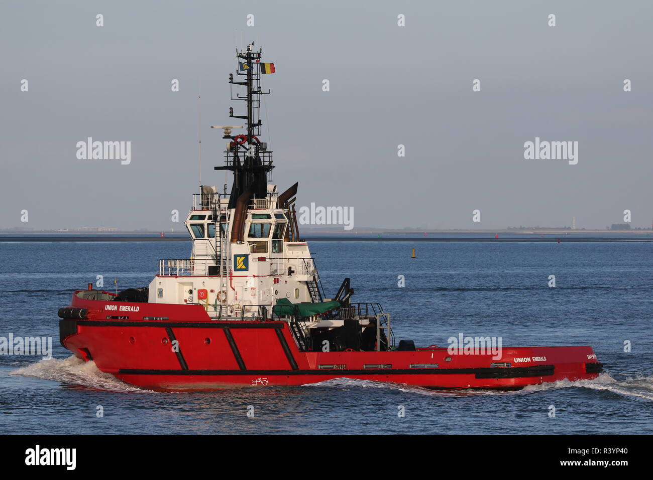 The harbor tug Union Emerald leaves Terneuzen on 19 October 2018 and heads for the North Sea. Stock Photo