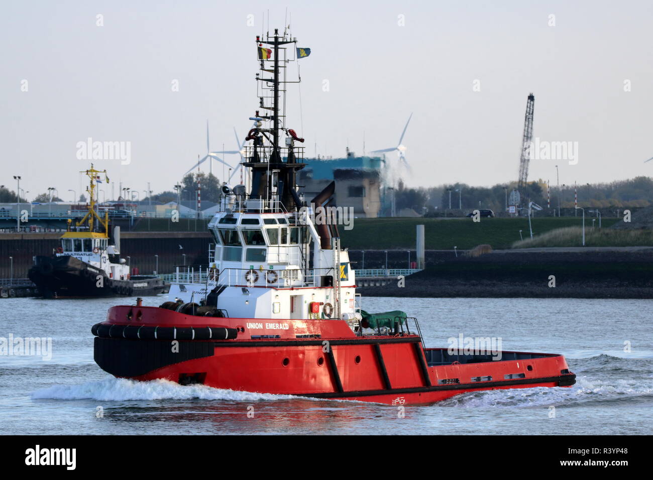 The harbor tug Union Emerald leaves Terneuzen on 19 October 2018 and heads for the North Sea. Stock Photo