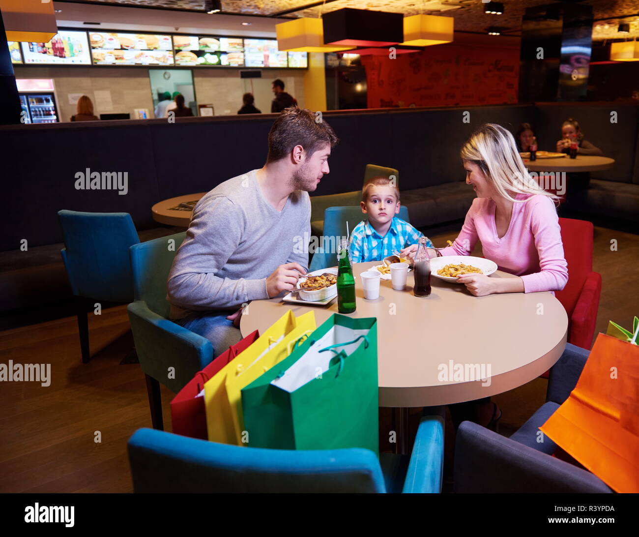 family having lunch in shopping mall Stock Photo