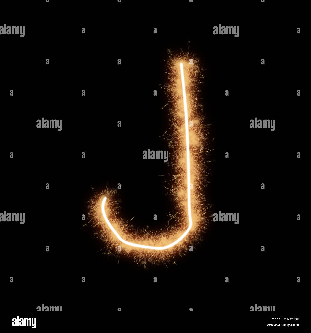 Letter J of alphabet written by squib sparks on a black background. Stock Photo