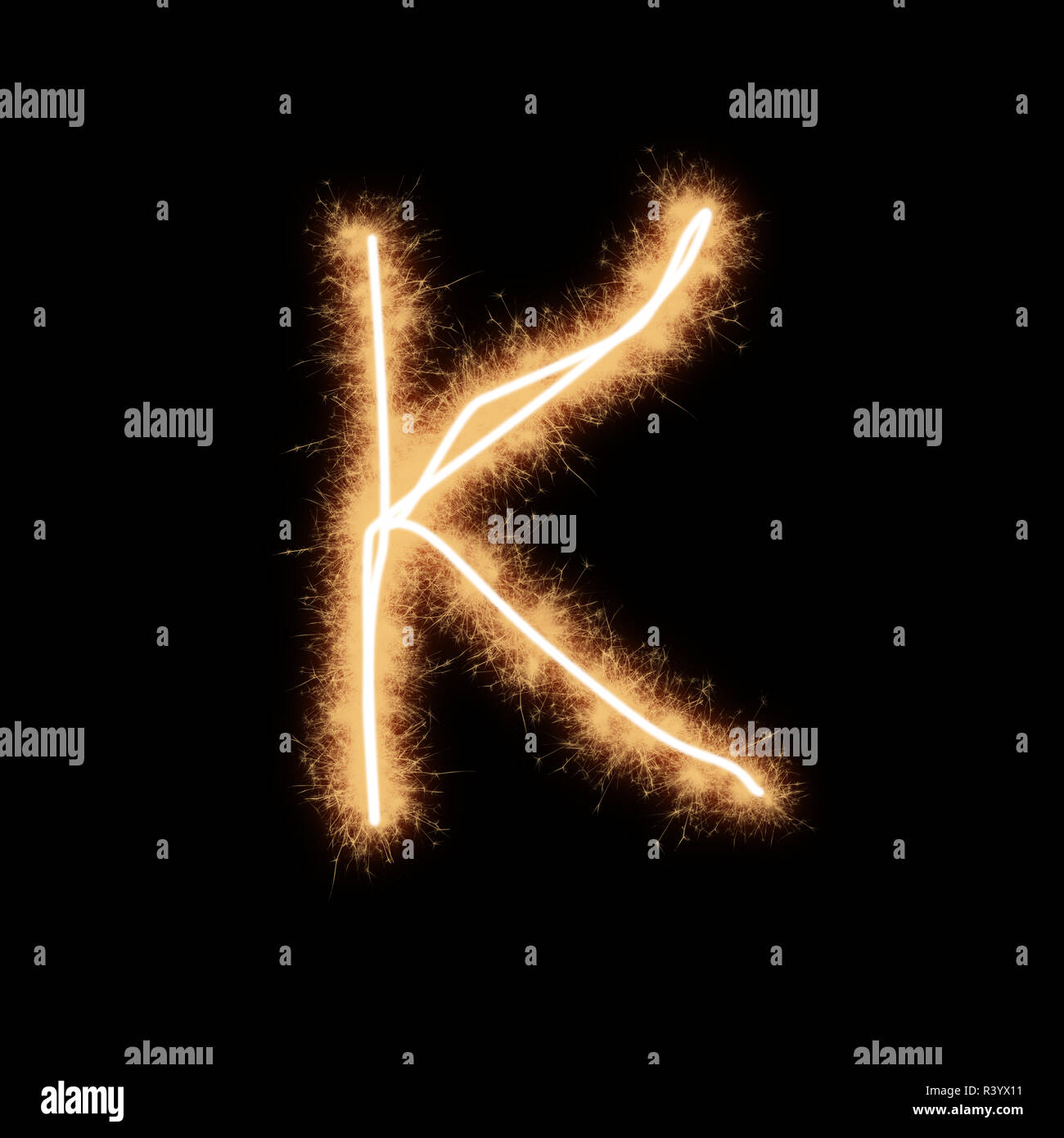 Letter K of alphabet written by squib sparks on a black background
