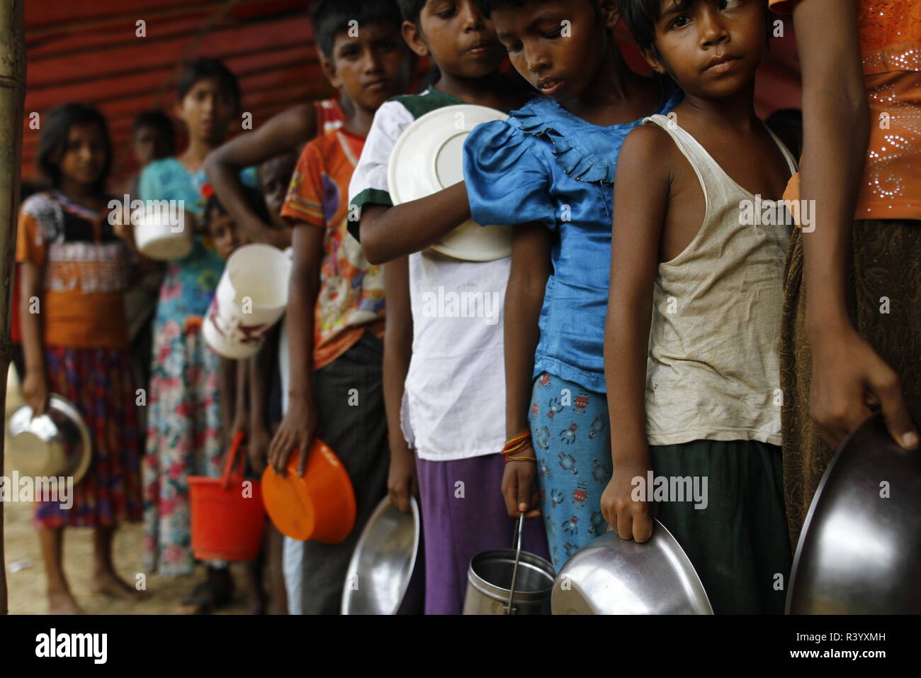 Cox’s Bazar, Bangladesh: Rohingya refugee children wait for food aid at ...