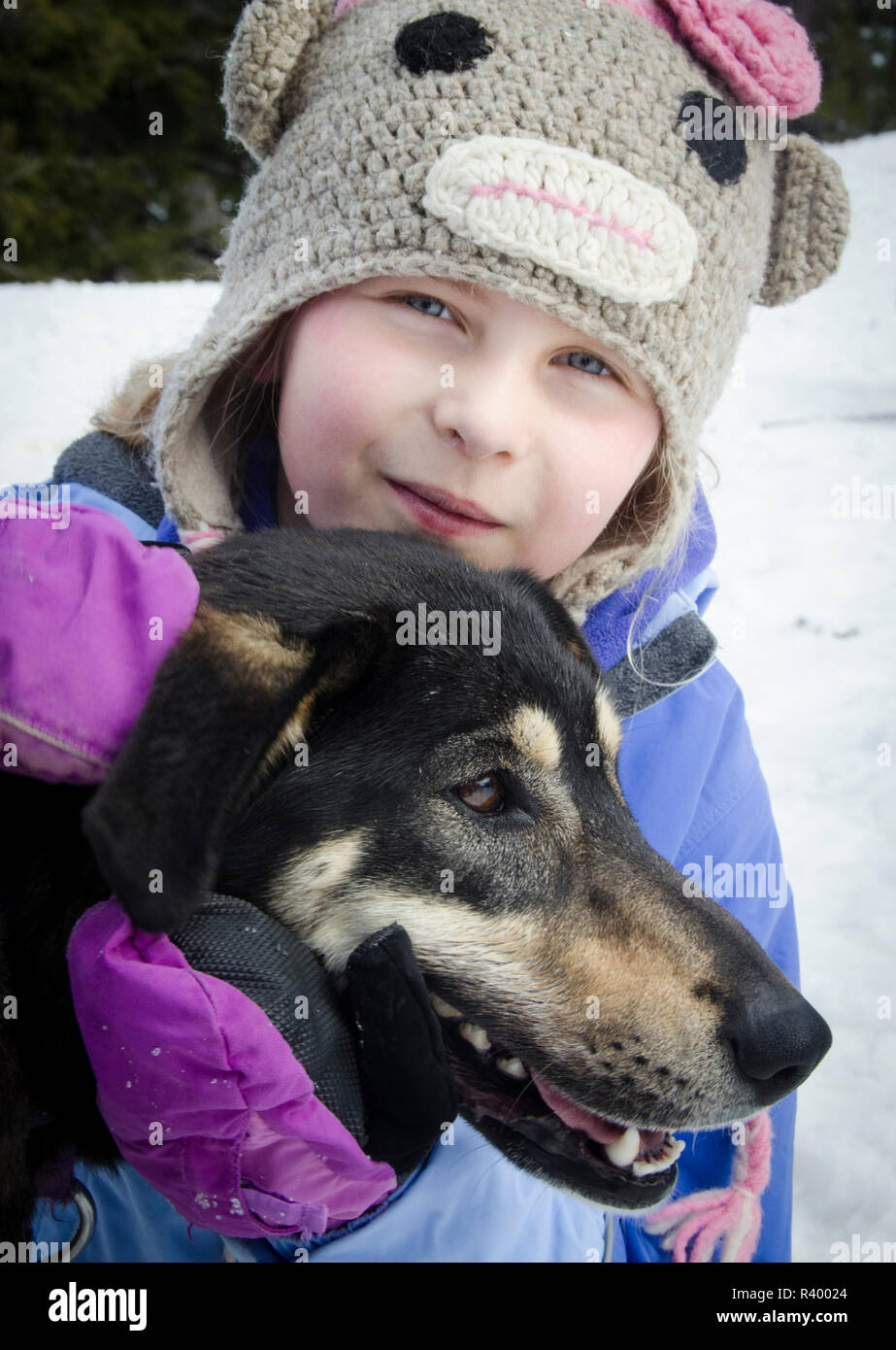 USA, Oregon, Deschutes National Forest. Mt. Bachelor, young girl and sled dog (MR). Stock Photo